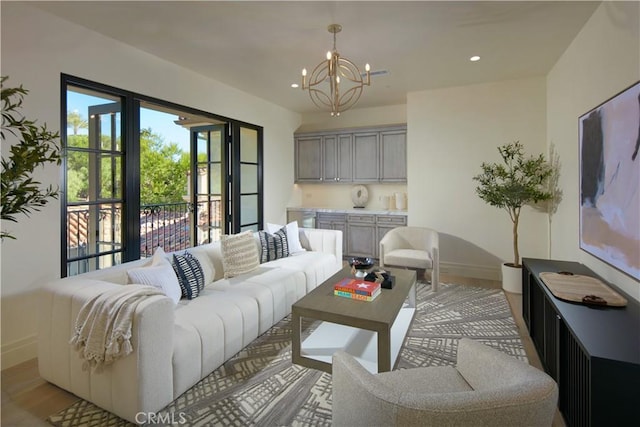 living room featuring an inviting chandelier and light hardwood / wood-style flooring