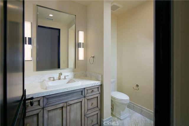 bathroom featuring toilet, vanity, and tile patterned floors