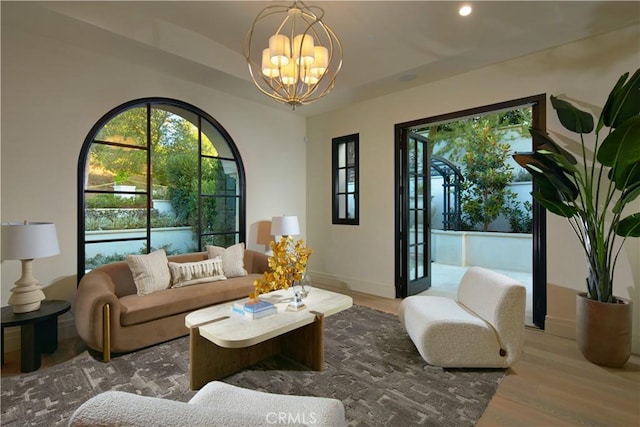 living room with a notable chandelier and hardwood / wood-style floors