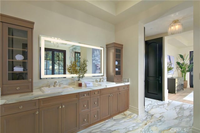 bathroom with a chandelier and vanity