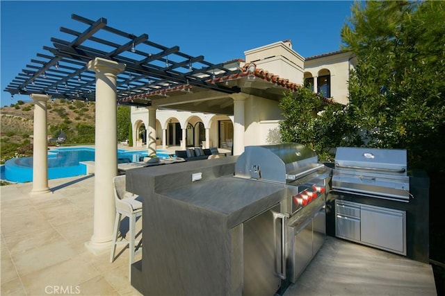 view of patio with an outdoor kitchen, a pergola, and a grill