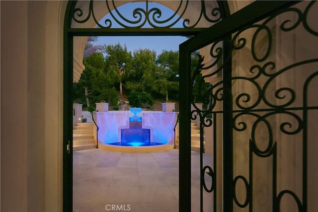 gate at dusk with a patio