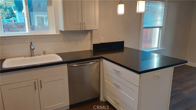 kitchen with dark hardwood / wood-style flooring, white cabinets, kitchen peninsula, sink, and dishwasher