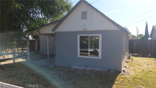 view of side of home featuring a lawn