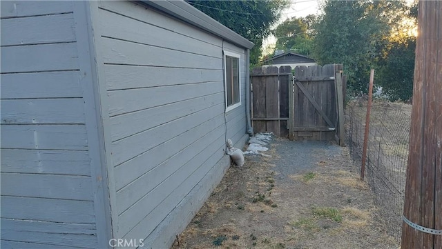 view of home's exterior featuring a gate and fence
