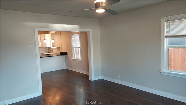 empty room featuring dark hardwood / wood-style floors and ceiling fan