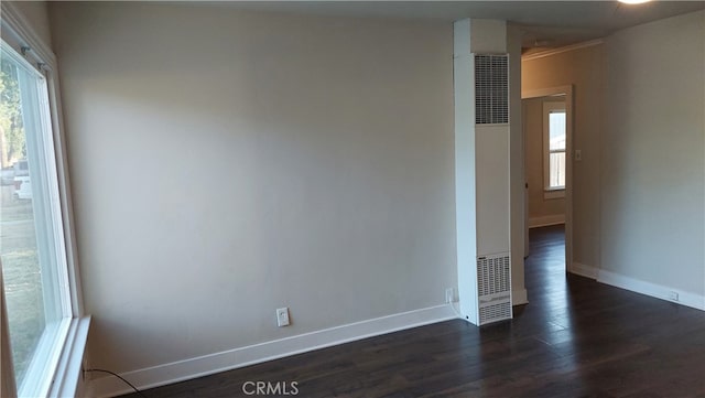 empty room with dark hardwood / wood-style floors