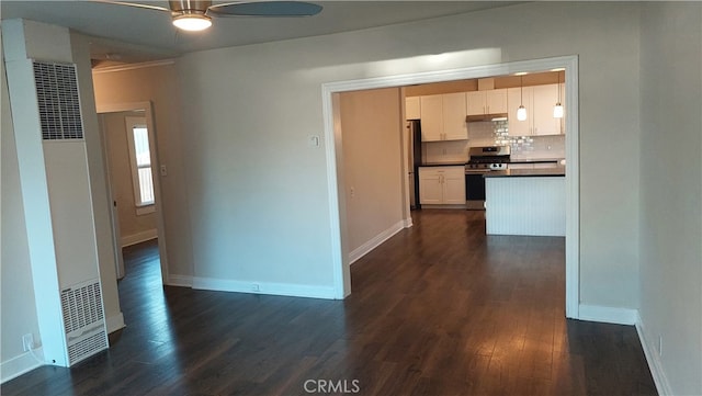 kitchen with ceiling fan, stainless steel appliances, dark hardwood / wood-style flooring, backsplash, and white cabinetry