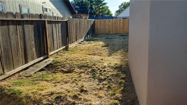 view of yard with a fenced backyard