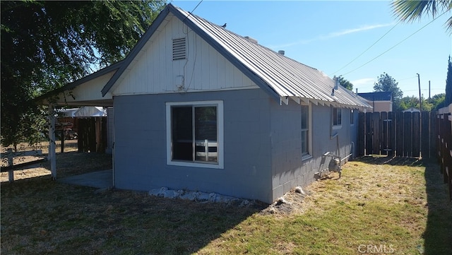 view of side of home with a lawn