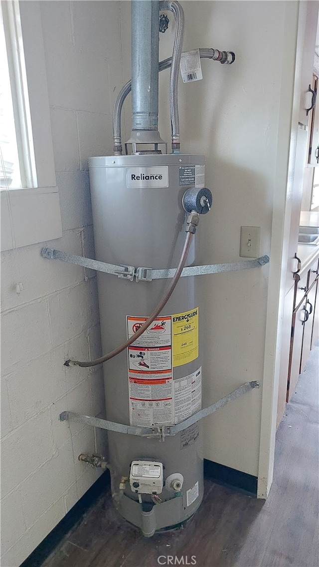 utility room featuring secured water heater