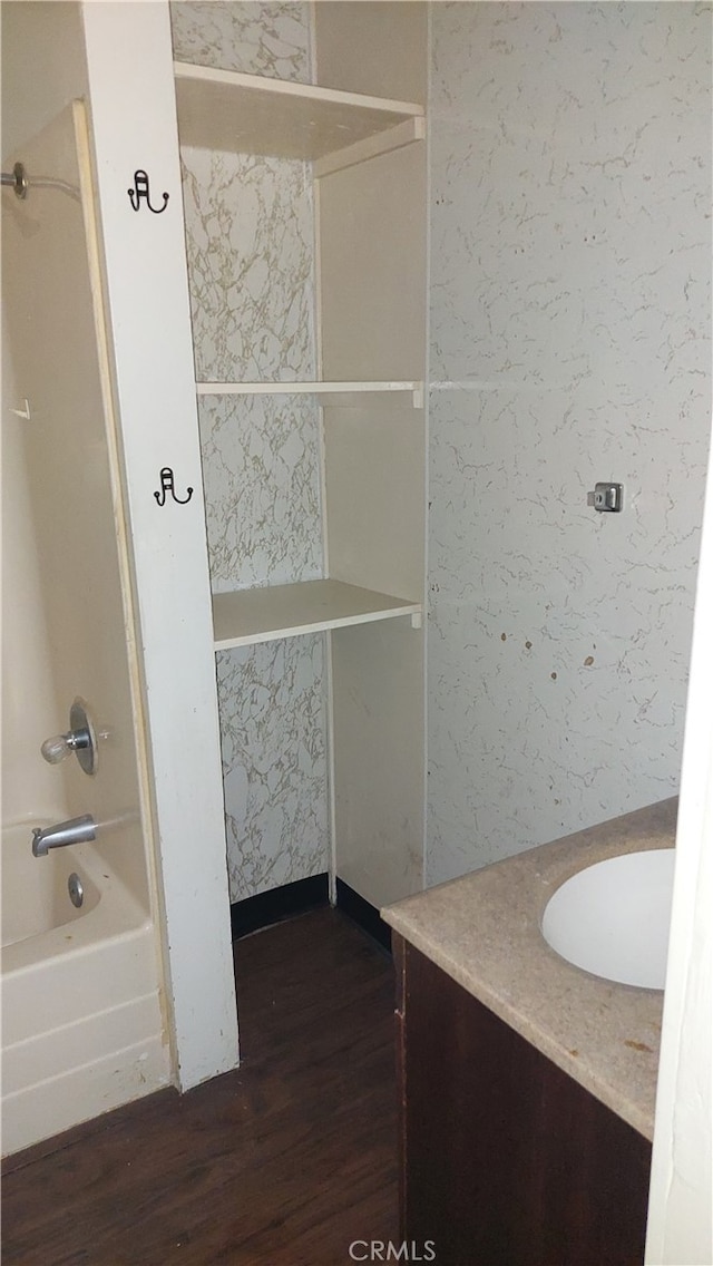 bathroom with vanity, hardwood / wood-style flooring, and shower / bathtub combination