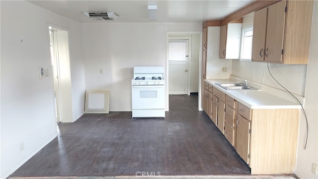 kitchen featuring sink, white range with gas stovetop, and dark wood-type flooring