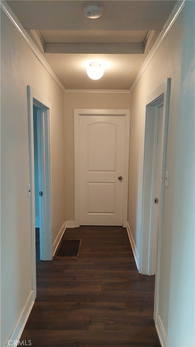 hallway with crown molding and dark wood-type flooring