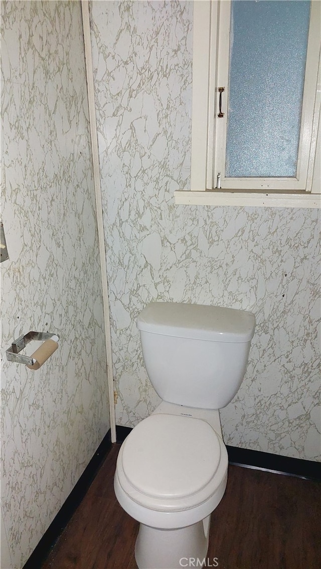 bathroom featuring hardwood / wood-style flooring and toilet