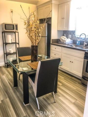 dining area with light hardwood / wood-style floors and sink