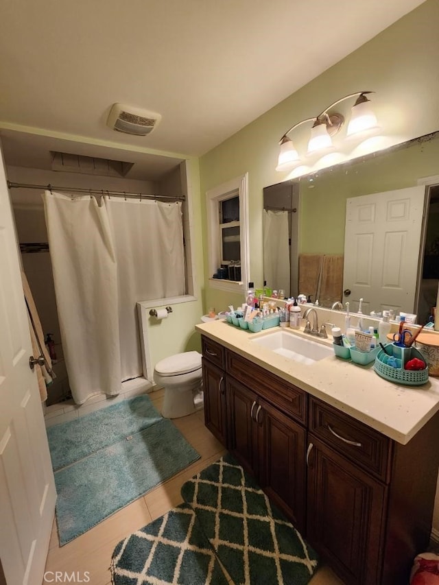 bathroom featuring tile patterned floors, vanity, and toilet