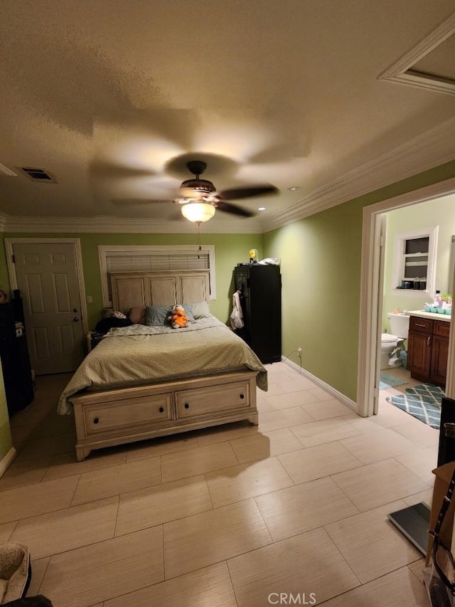 bedroom featuring ensuite bath, ceiling fan, a textured ceiling, and ornamental molding