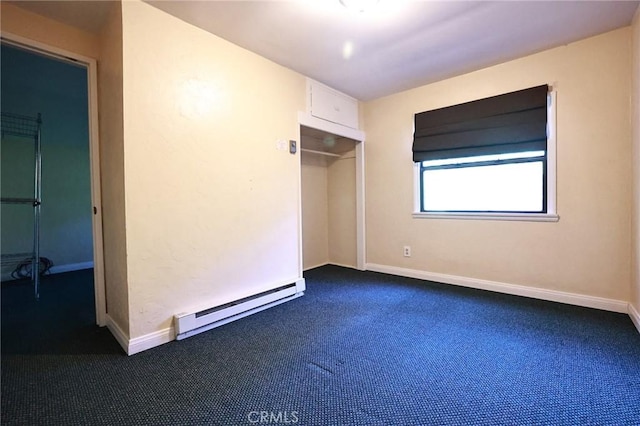 unfurnished bedroom with dark colored carpet, baseboard heating, and a closet