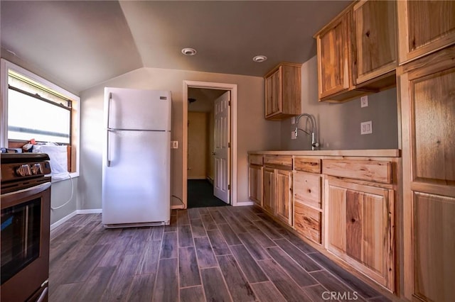 kitchen featuring stainless steel electric range oven, sink, dark hardwood / wood-style flooring, white fridge, and vaulted ceiling