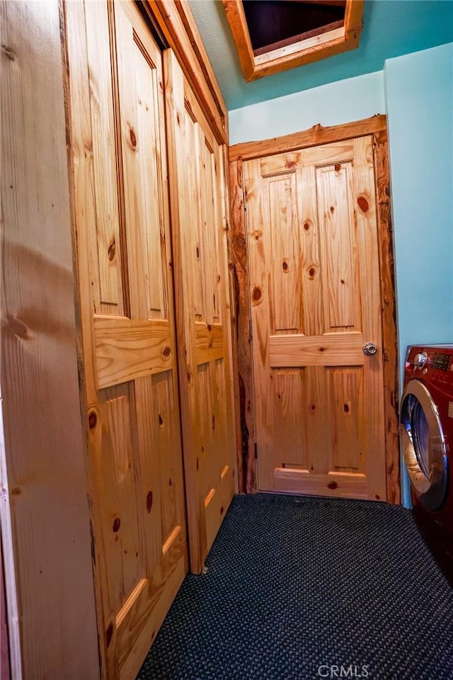 interior space featuring carpet and washer / clothes dryer