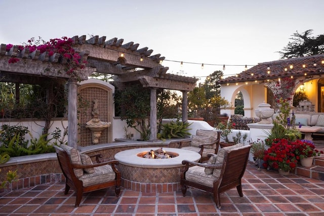 view of patio / terrace with a pergola and an outdoor fire pit