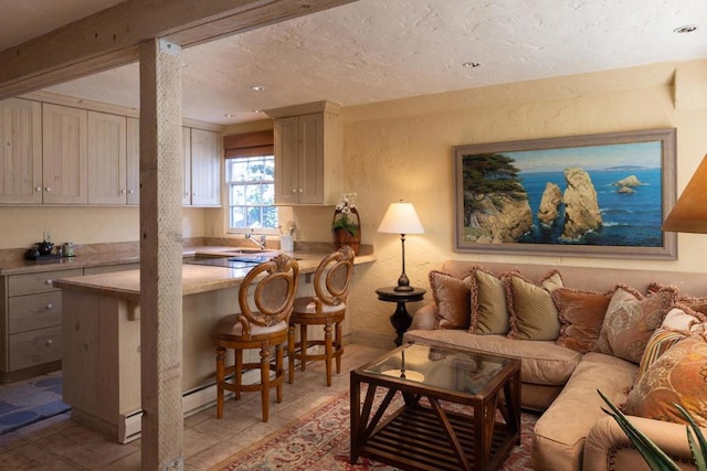 living room featuring light tile patterned floors, a textured ceiling, and sink