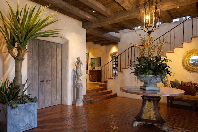 entryway featuring beamed ceiling and wooden ceiling