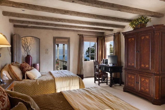 bedroom with beamed ceiling and light colored carpet