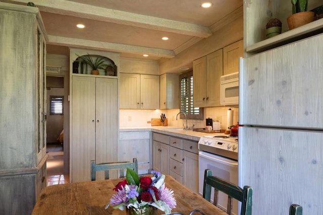 kitchen with light brown cabinetry, tasteful backsplash, white appliances, crown molding, and sink