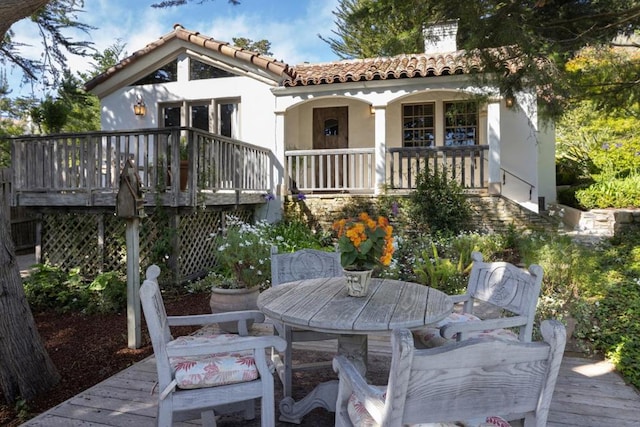 back of house featuring a wooden deck