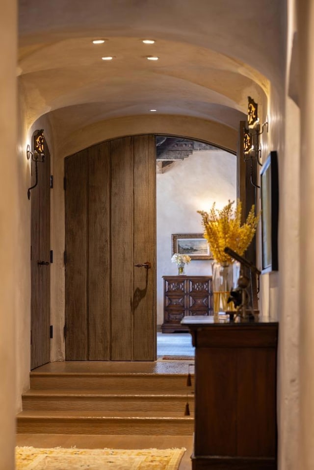 staircase with hardwood / wood-style flooring and vaulted ceiling