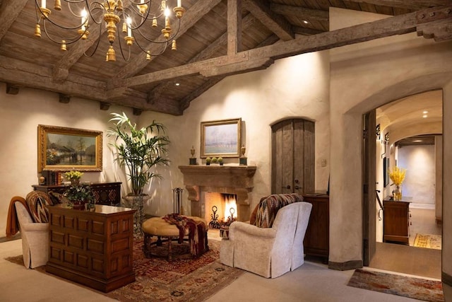 sitting room with beam ceiling, wooden ceiling, carpet floors, and an inviting chandelier