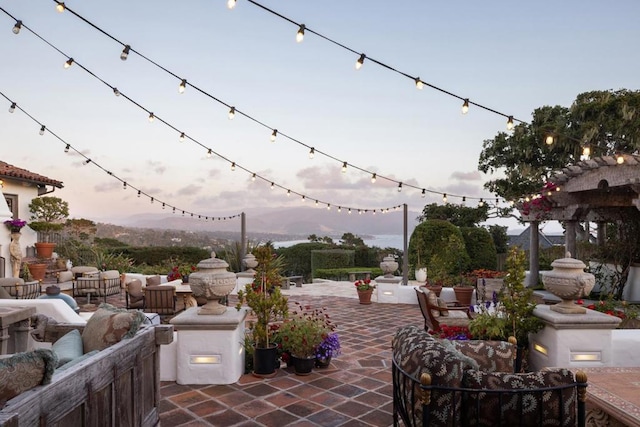 patio terrace at dusk featuring an outdoor living space