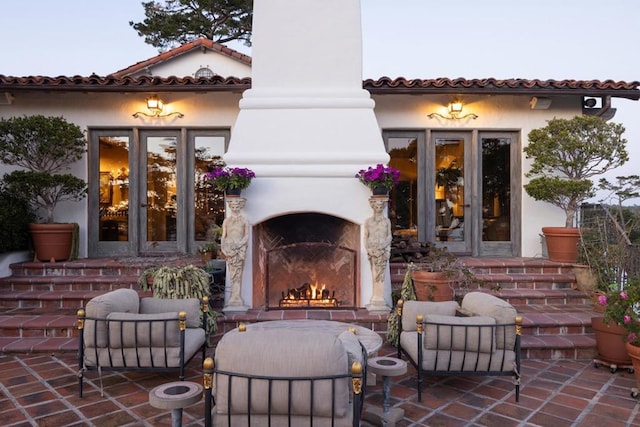 view of patio with exterior fireplace