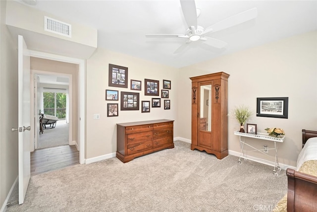 bedroom with light carpet and ceiling fan