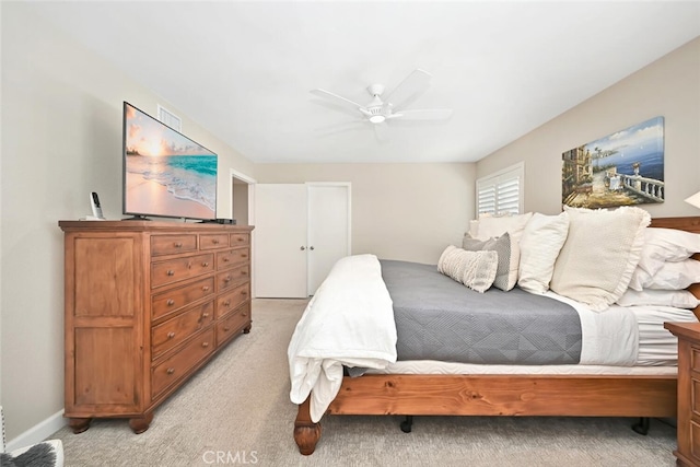 bedroom with ceiling fan and light colored carpet