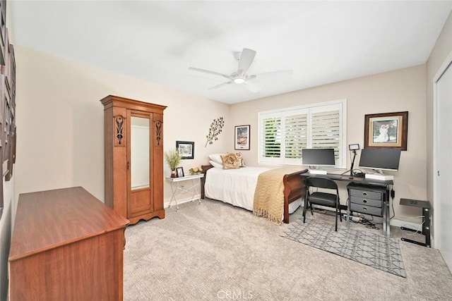 bedroom featuring light carpet and ceiling fan