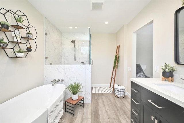 bathroom featuring wood-type flooring, vanity, and independent shower and bath