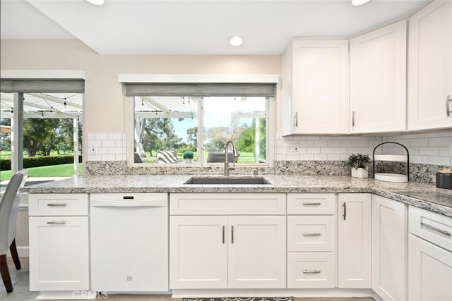 kitchen with dishwasher, white cabinetry, a healthy amount of sunlight, and sink