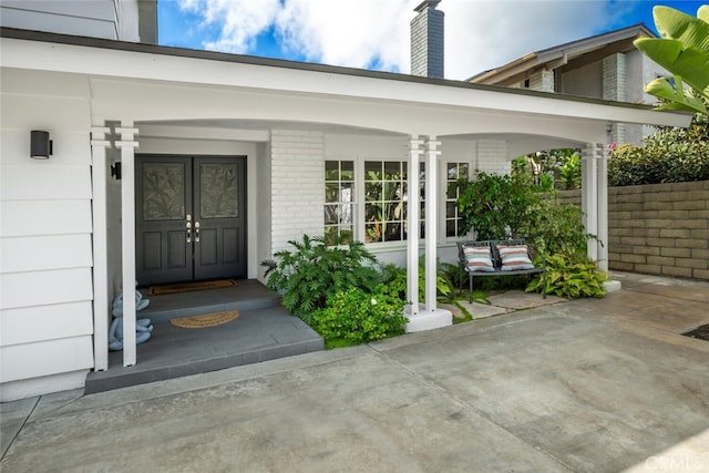 view of exterior entry with covered porch