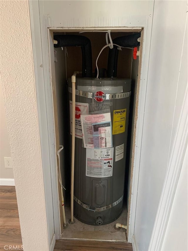 utility room with strapped water heater