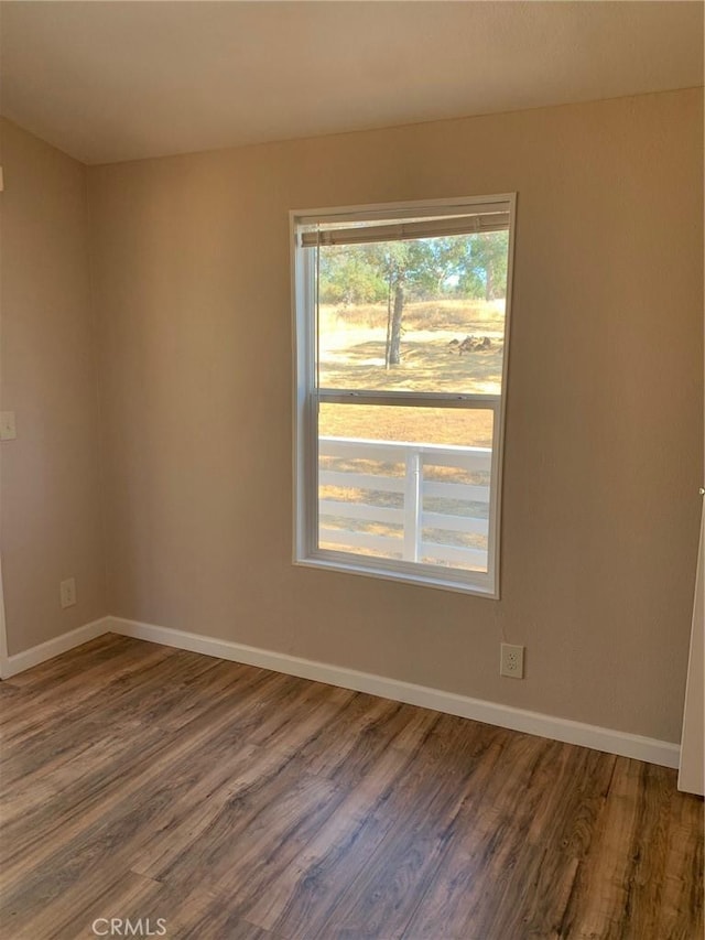 spare room with dark wood-type flooring