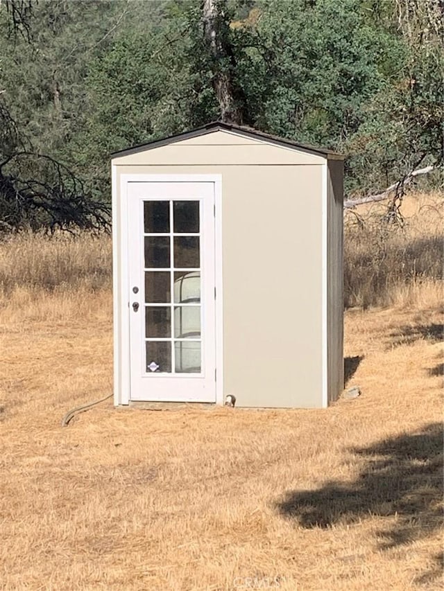 view of outbuilding with a yard