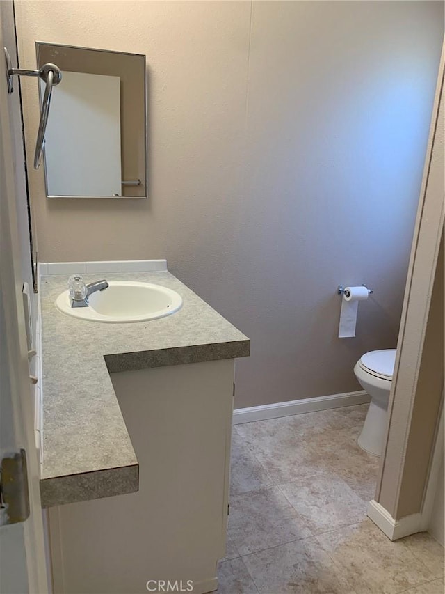 bathroom featuring toilet and vanity