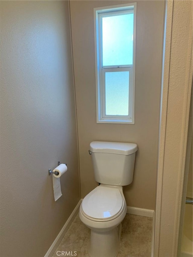 bathroom featuring toilet and tile patterned flooring