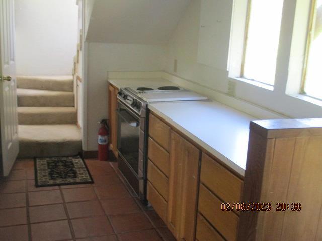 kitchen featuring dark tile patterned floors and range