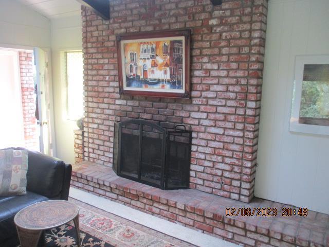 living room with a fireplace and vaulted ceiling