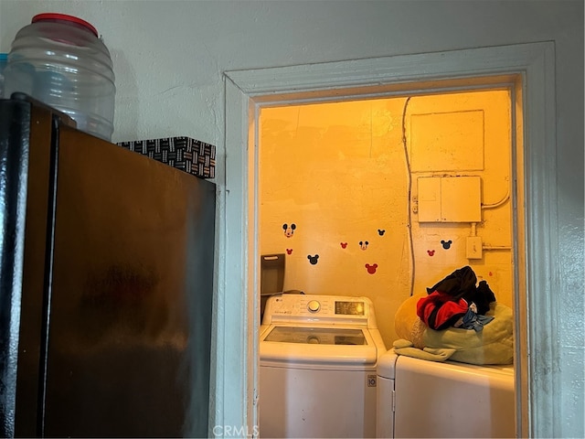 clothes washing area with separate washer and dryer