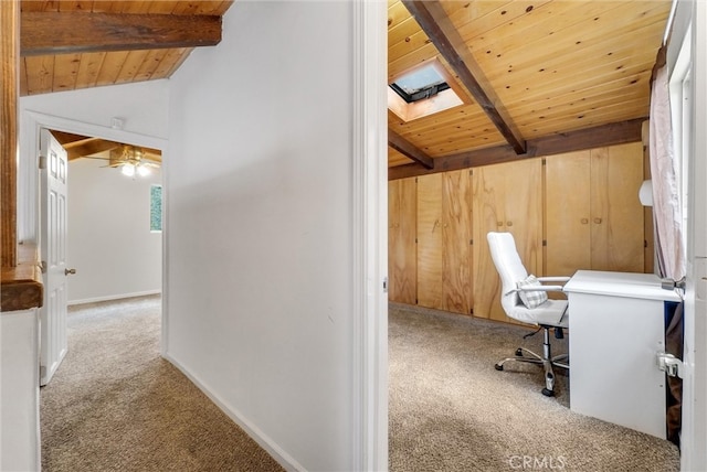 unfurnished office with lofted ceiling with beams, ceiling fan, wooden ceiling, and light colored carpet